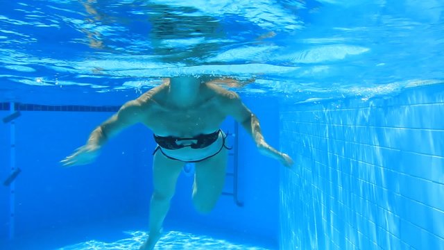 Woman swim in blue pool