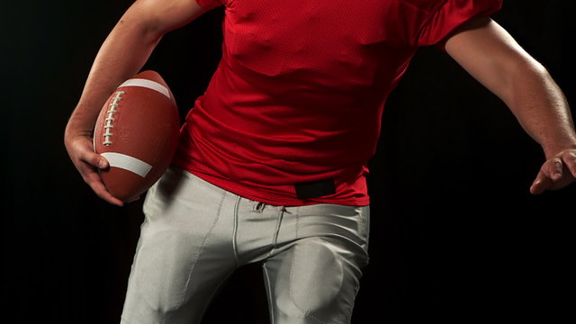 American footblall player with red jersey playing