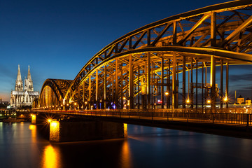 Hohenzollern Bridge and Cologne Cathedral at dusk in Cologne, Germany.
