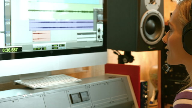 Student mixing music in the studio