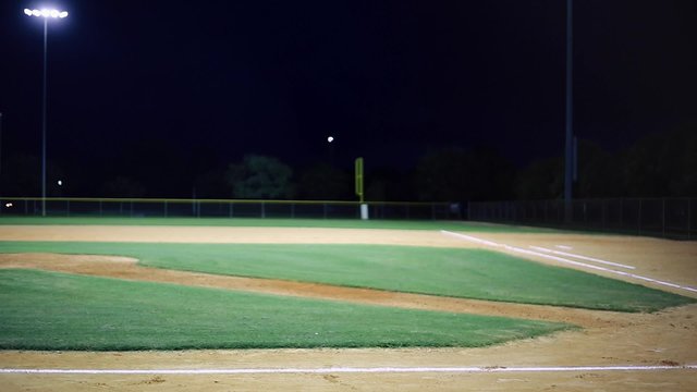 Evening shot of empty baseball field.  Some lightning in the sky.