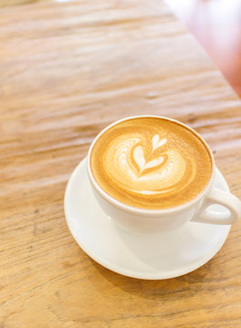 Cup of coffee latte art on wood table