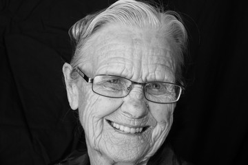 elderly woman wearing eyeglasses smiling