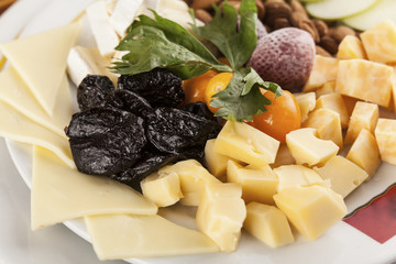 A cheese tray with fruit food party