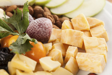 A cheese tray with fruit food party