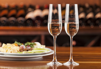two glasses of champagne with a tray of cheese and reserved message