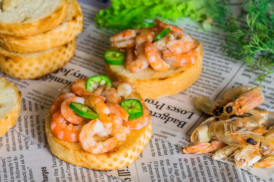 Tapas appetizers with shrimp on paper