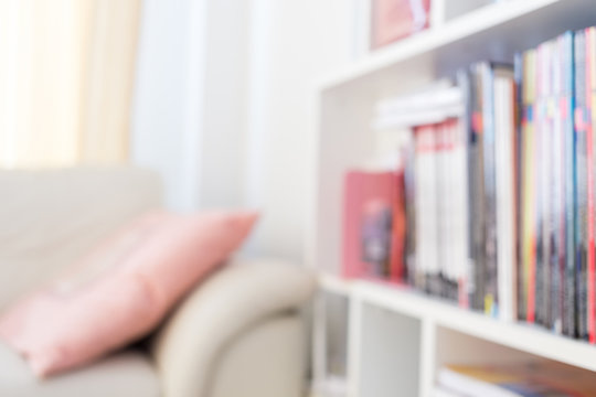 blur image background, book shelf and sofa furniture interior