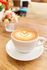 Cup of coffee latte art on wood table