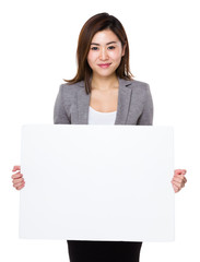 Fototapeta premium Businesswoman showing with the white banner