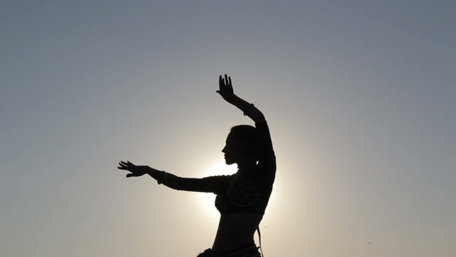 Silhouette girl dancing exotic dance 