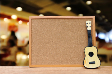 cork board and small guitar with blur restaurant