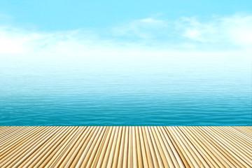Fototapeta premium perspective bamboo floor on blur ocean background