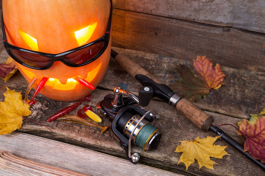 halloween pumpkin in eyeglass with fishing tackles