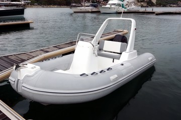 White Inflatable Rubber Speed Motor Boat At The Berth