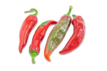 Several red and green peppers chili on a light background