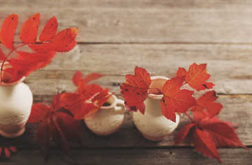 Fototapeta na wymiar Autumn Leaves over wooden background