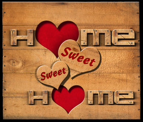 Home Sweet Home - Wooden Wall / Wooden text Home sweet home with two hearts on a wooden wall isolated on a black background