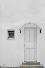 Old Whitewashed House Facade With Small White  Window And Door