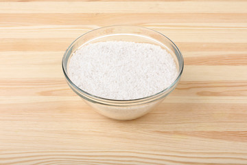 sea salt in bowl on wooden background