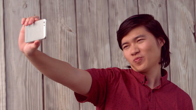 Happy hipster taking selfie with phone