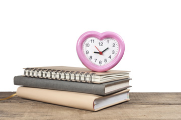 stack of books and an alarm clock