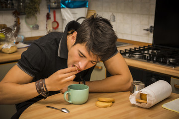 Tired Man with Coffee Sitting at Kitchen Table