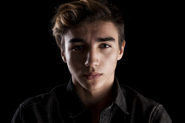 portrait of a young handsome man on black background