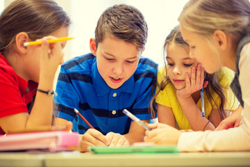 group of students talking and writing at school