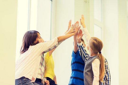 Group Of School Kids Making High Five Gesture