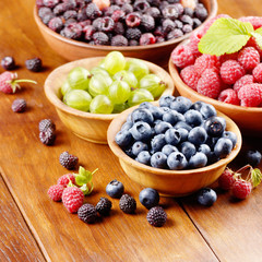 Wooden bowls with organic berries