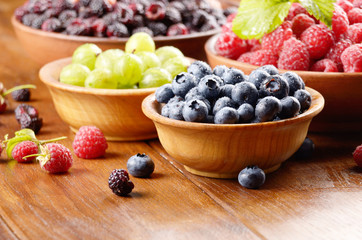 Wooden bowls with organic berries