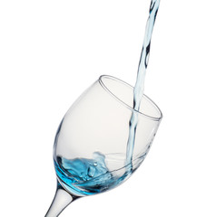 Water flowing into glass with white background