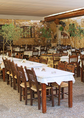 Mediterranean restaurant terrace exterior with chairs.