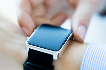 close up of hands setting smart watch