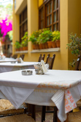 Mediterranean restaurant terrace exterior with chairs.