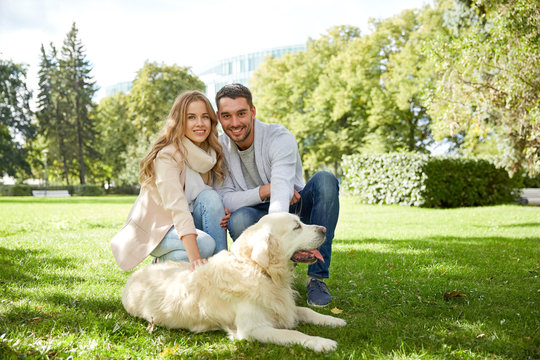 happy couple with labrador dog walking in city