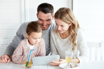 happy family with tablet pc at restaurant