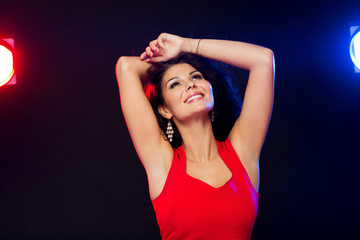 beautiful sexy woman in red dancing at nightclub