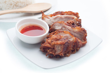 Chicken and  spicy sauce on the plate and white background, food