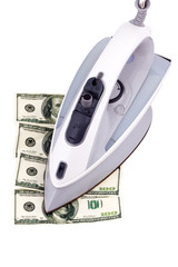 Iron smoothes dollars on a white background