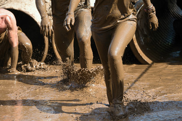 Fototapeta na wymiar Mud race runners
