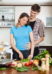 Young couple hugging in kitchen