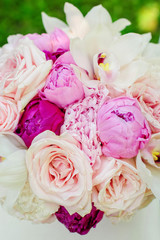 Beauty of colored flowers. Bridal accessories. Close-up bunch of florets. Details for marriage and for married couple. Wedding bouquet with peonies, roses and orchids 