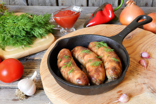 Grilled meat sausages in a pan