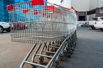Set of supermarket trolleys on mall parking lot