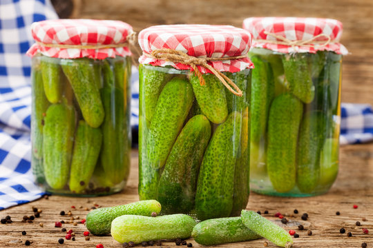 Jars of canned pickles with peppers