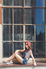 portrait of young woman, sitting at windowsill