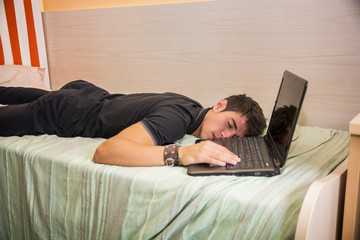 Tired Young Man Sleeping Next Laptop Computer