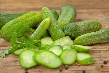 Fresh ripe green organic cucumbers on a wooden table